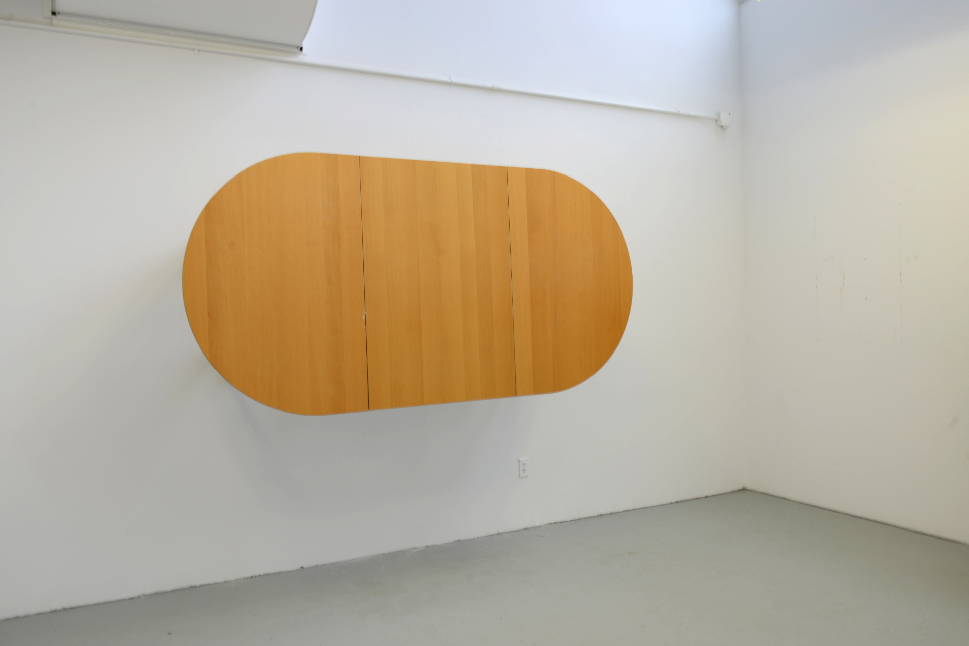 Artwork by Petros Chrisostomou in his Banff Centre Studio. Table on a wall.