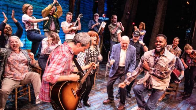 A group of actors and musicians on stage