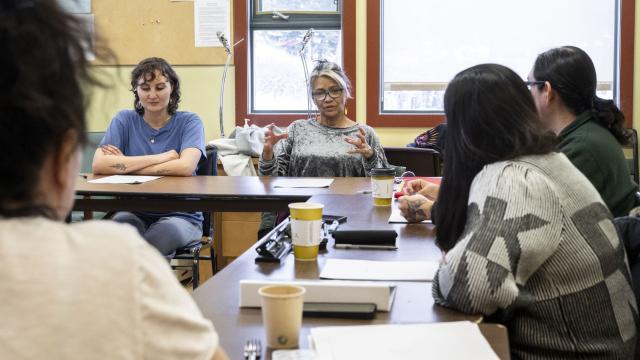 A group of writers are seated around the room