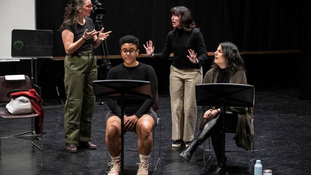Two playwrights and two ASL interpreters interact on stage