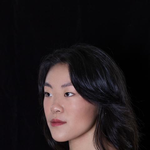 Side portrait of woman facing her right with shoulder length hair 