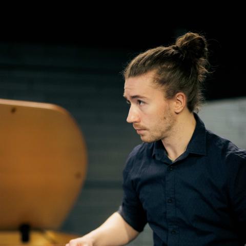 Action shot of Alexander playing percussion instrument