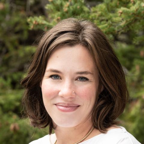 Jacqueline Bell standing outside in summer smiling at camera