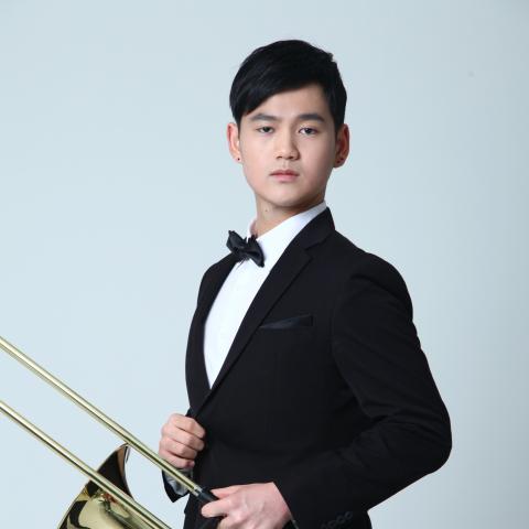 Man in tuxedo holding trombone