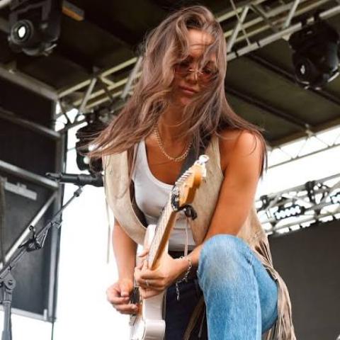 Woman playing rock guitar
