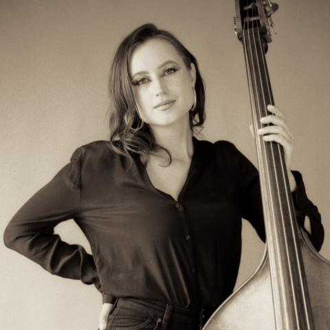 Black and white photo of woman standing with upright bass