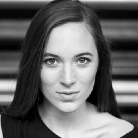 Close up black and white headshot of woman staring intently at camera