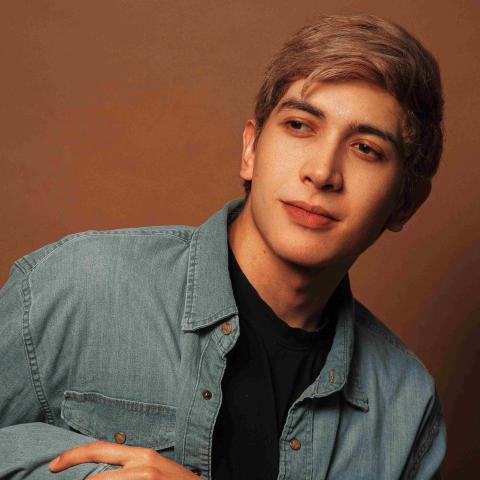 Casually dressed, Montana leans to the right looking off camera