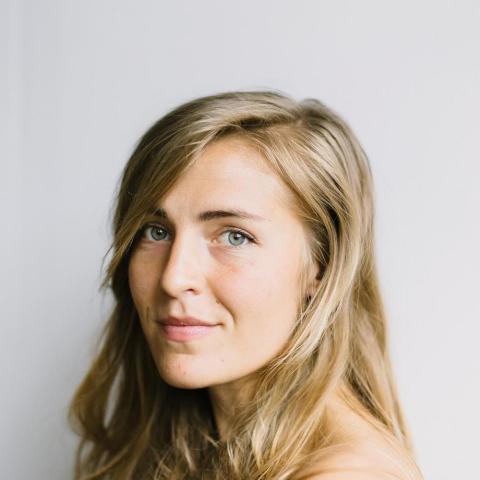 A headshot of Hannah in front of a white background. 