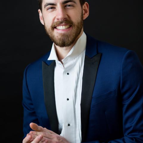 Smiling man in blue and white 